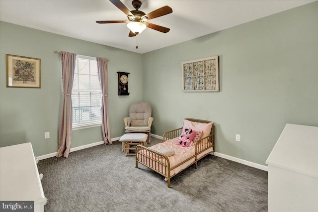 living area with a ceiling fan, dark carpet, and baseboards