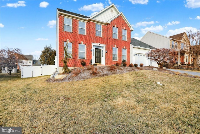 view of front of home featuring a garage, brick siding, a front lawn, and fence