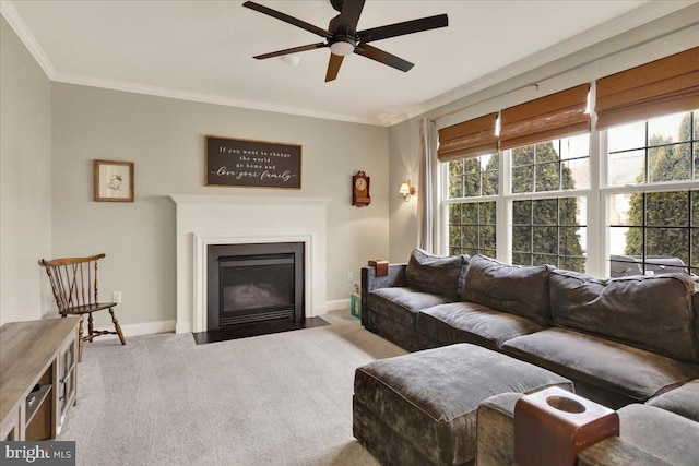 living room featuring light carpet, a fireplace with flush hearth, baseboards, and crown molding