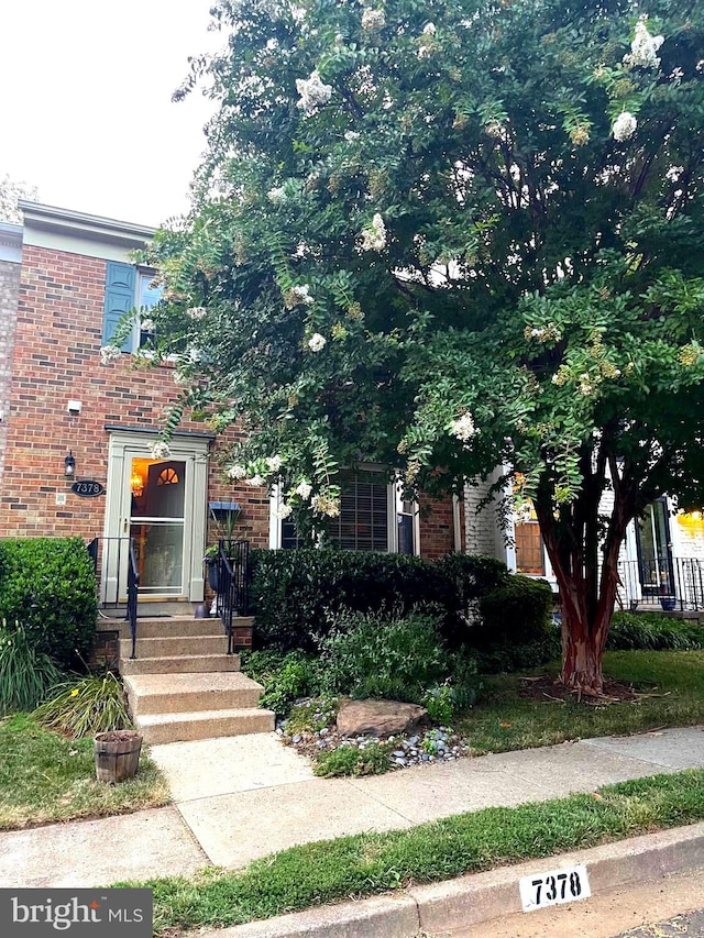 view of front of home with brick siding