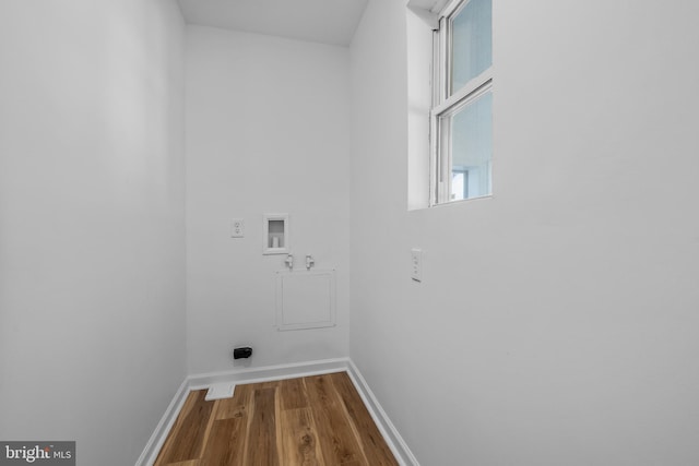 laundry area featuring washer hookup, electric dryer hookup, wood finished floors, laundry area, and baseboards