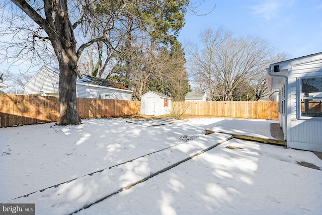 exterior space with a storage shed, a fenced backyard, and an outdoor structure