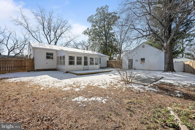 rear view of house featuring fence