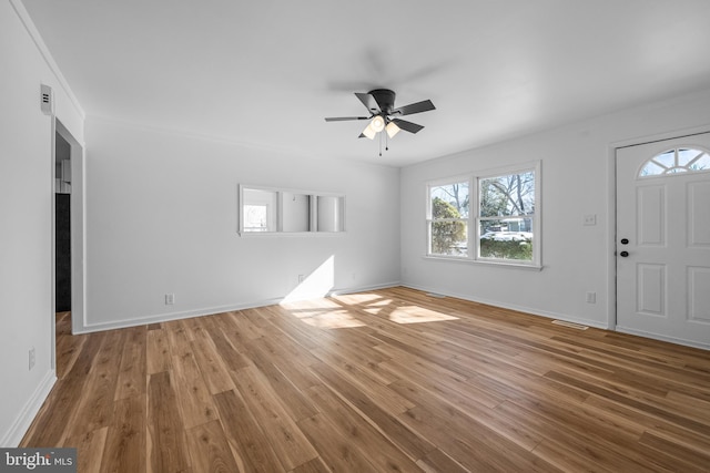 foyer featuring a ceiling fan, baseboards, and wood finished floors