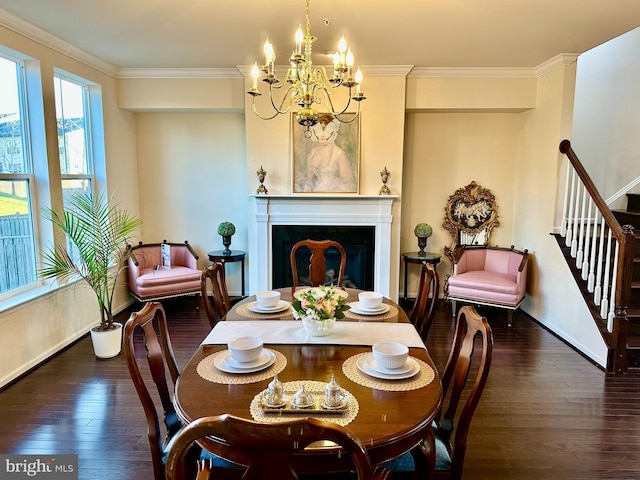 dining space featuring a fireplace, crown molding, a notable chandelier, dark wood-type flooring, and stairs