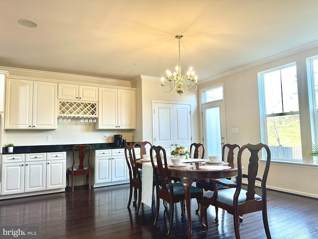 dining room with a chandelier, ornamental molding, dark wood-type flooring, and baseboards