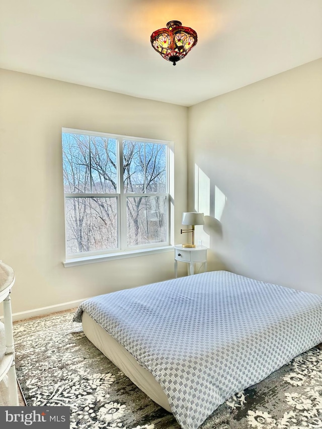 bedroom with carpet and baseboards