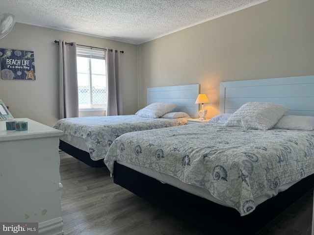 bedroom featuring a textured ceiling and wood finished floors