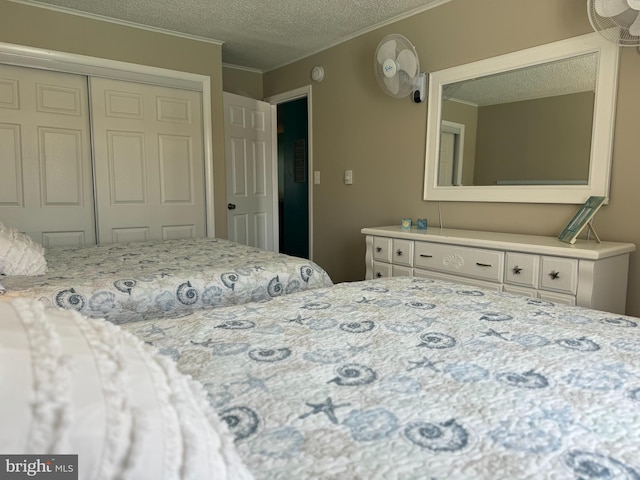 bedroom with ornamental molding, a closet, and a textured ceiling