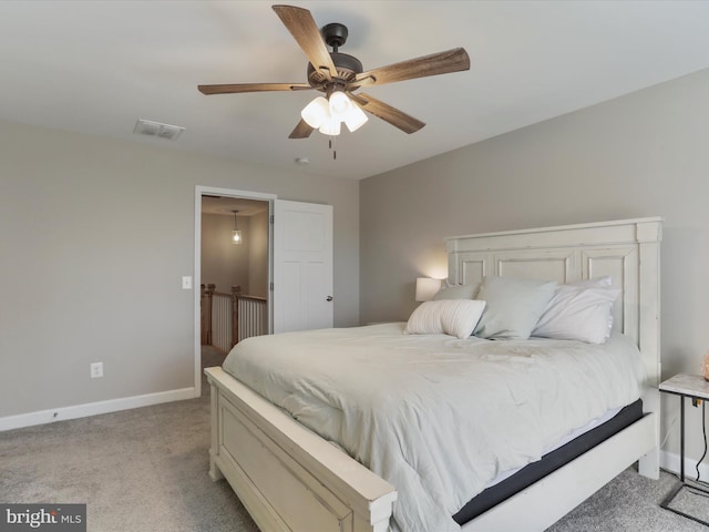 bedroom featuring baseboards, ceiling fan, visible vents, and light colored carpet