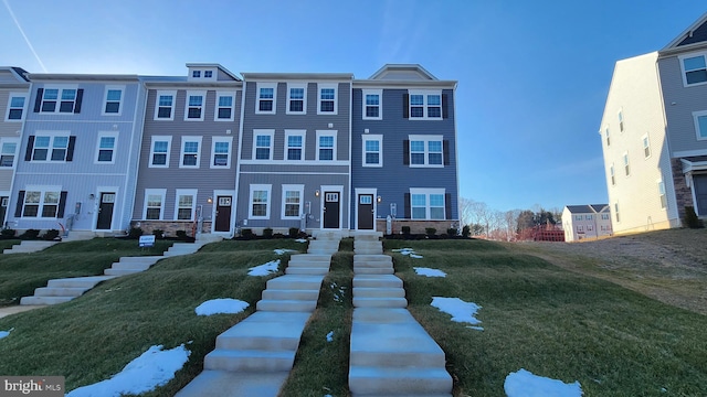 view of property featuring a front lawn