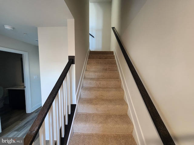 stairway featuring baseboards