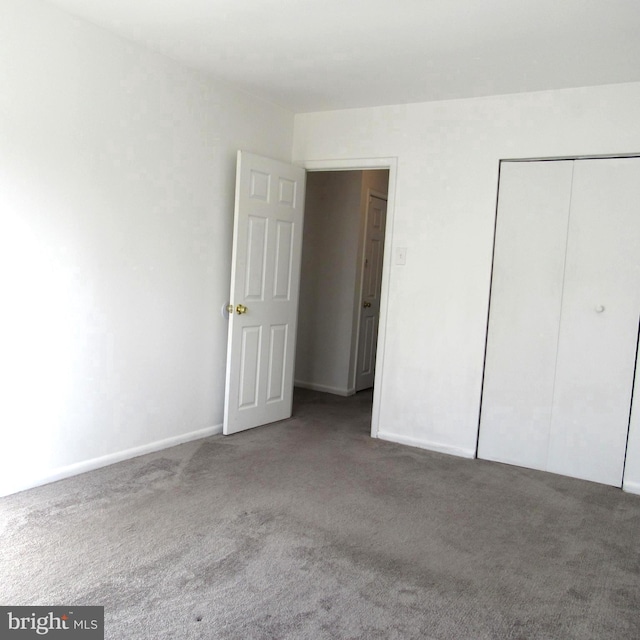 unfurnished bedroom with a closet and carpet flooring