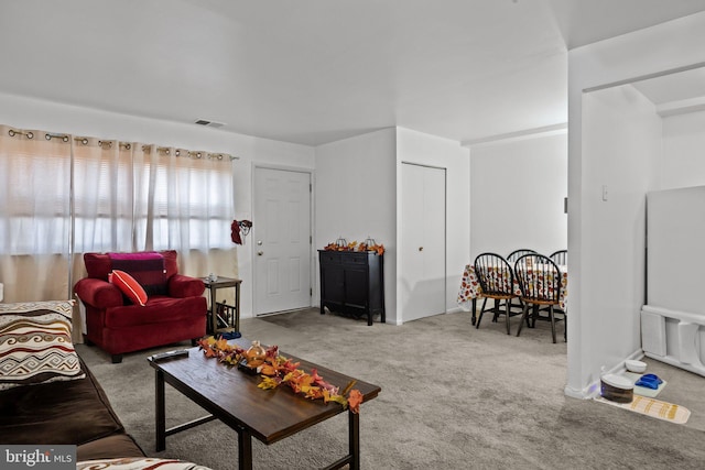 living room with carpet and visible vents