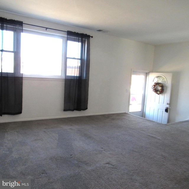 spare room with carpet floors and visible vents