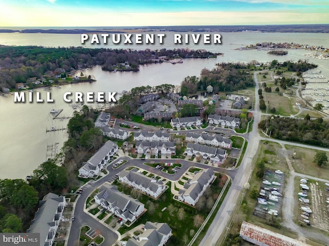 birds eye view of property with a water view and a residential view