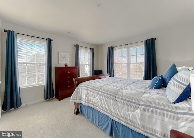 carpeted bedroom with multiple windows