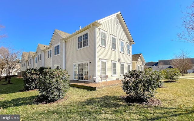 back of property with a wooden deck, a residential view, and a yard