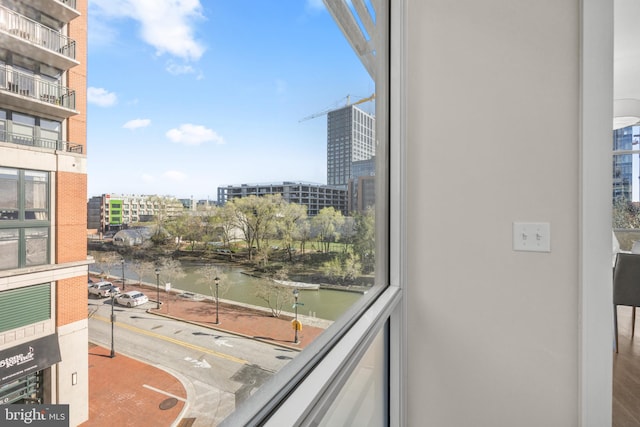 balcony featuring a water view and a view of city