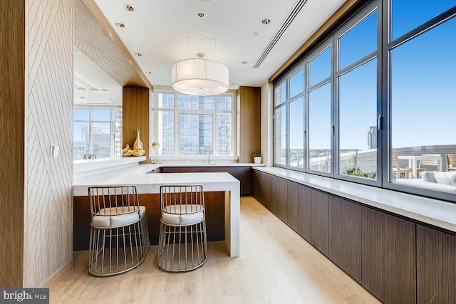 interior space with a view of city and light wood-type flooring