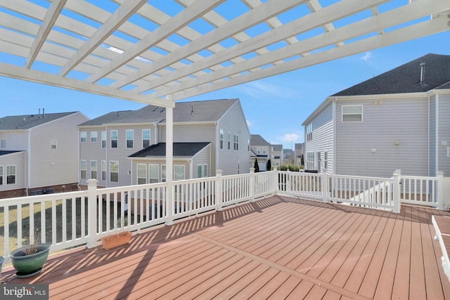 wooden deck with a residential view and a pergola