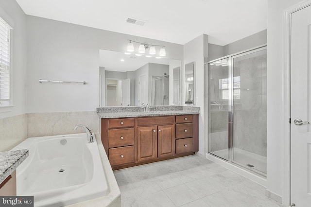 bathroom featuring marble finish floor, visible vents, a shower stall, vanity, and a bath