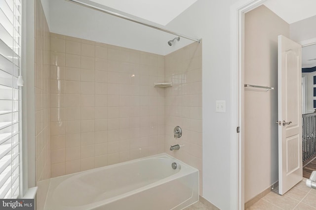 bathroom with washtub / shower combination, baseboards, and tile patterned floors