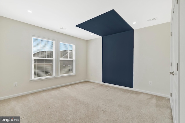 unfurnished room featuring light carpet, recessed lighting, visible vents, and baseboards