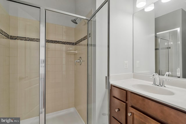 full bath featuring a shower stall and vanity