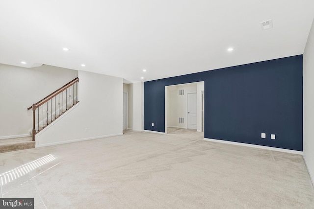 spare room featuring recessed lighting, visible vents, stairway, light carpet, and baseboards