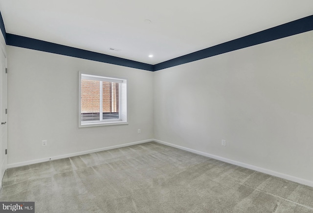 empty room with light carpet, visible vents, baseboards, and recessed lighting