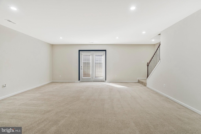 empty room featuring baseboards, visible vents, light colored carpet, stairway, and recessed lighting