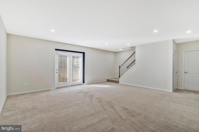 unfurnished living room with stairs, recessed lighting, baseboards, and light colored carpet