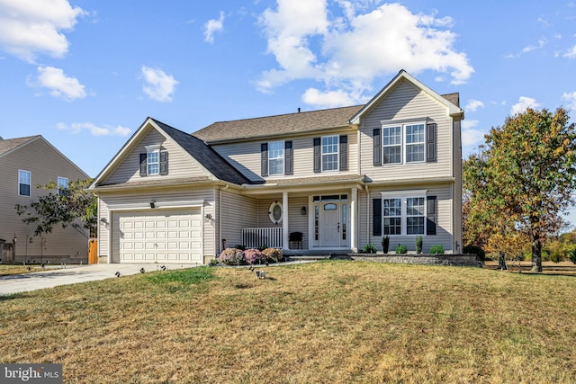 traditional-style home with covered porch, concrete driveway, a front yard, and a garage