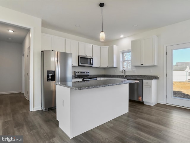 kitchen with dark wood finished floors, white cabinets, a center island, and stainless steel appliances