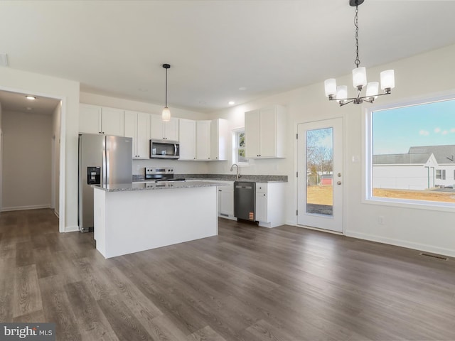 kitchen featuring stainless steel appliances, dark wood-type flooring, visible vents, and white cabinets