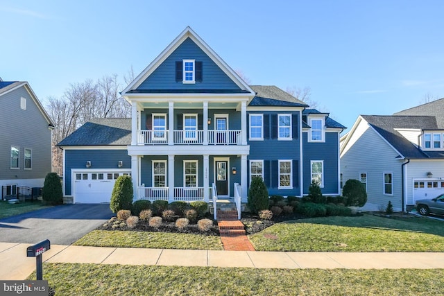 view of front of home with a porch, a front yard, a balcony, a garage, and driveway