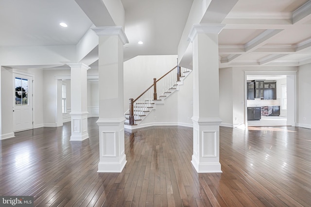 foyer with dark wood-type flooring, coffered ceiling, decorative columns, and baseboards