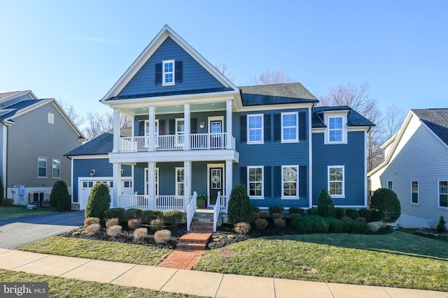 view of front of house featuring driveway, central AC unit, a balcony, covered porch, and a front yard