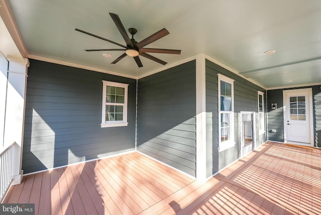 wooden terrace with a ceiling fan