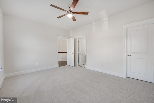 unfurnished bedroom with light carpet, ceiling fan, and baseboards