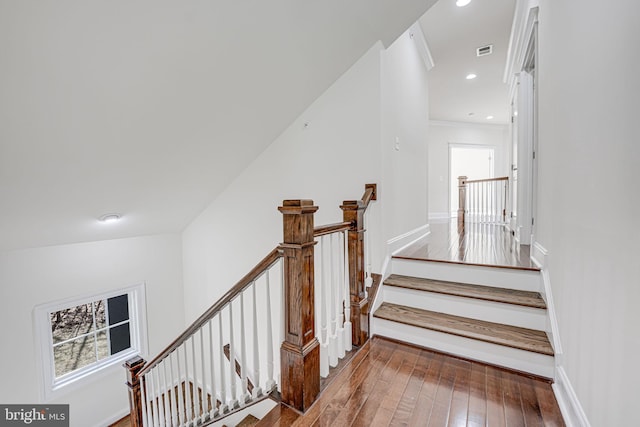 stairs with baseboards, wood finished floors, visible vents, and recessed lighting