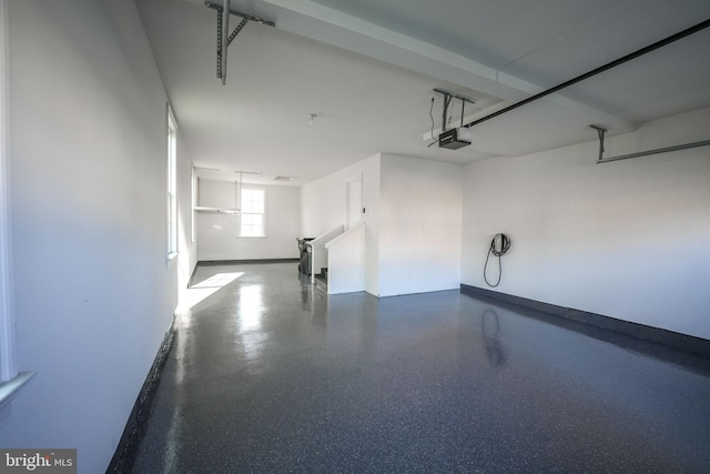 garage featuring baseboards and a garage door opener