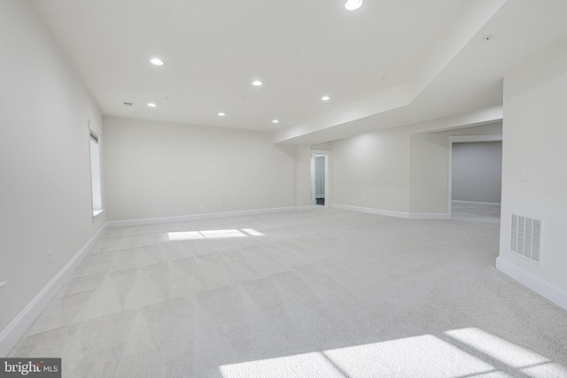 spare room with baseboards, light carpet, visible vents, and recessed lighting