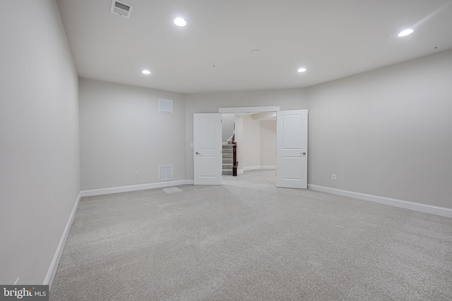 empty room with baseboards, stairs, visible vents, and recessed lighting