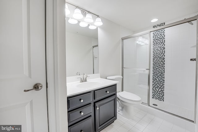 bathroom featuring a stall shower, vanity, toilet, and tile patterned floors