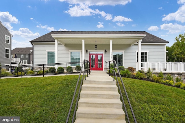 view of front of house featuring roof with shingles, a front yard, fence, and french doors