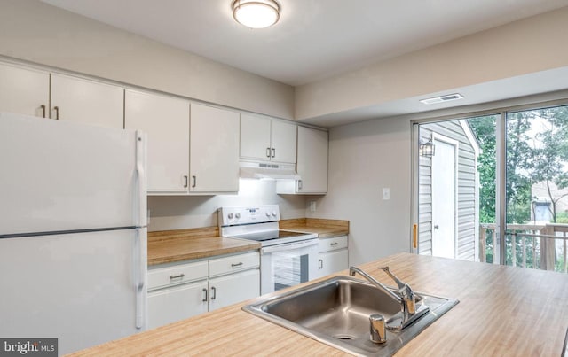 kitchen with white appliances, visible vents, white cabinets, under cabinet range hood, and a sink