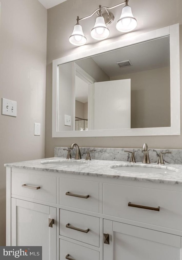 full bathroom with visible vents, a sink, and double vanity