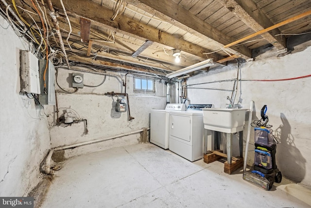 basement with a sink and washer and dryer